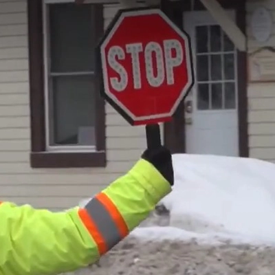 2In use image of gaurd using stop paddle sign