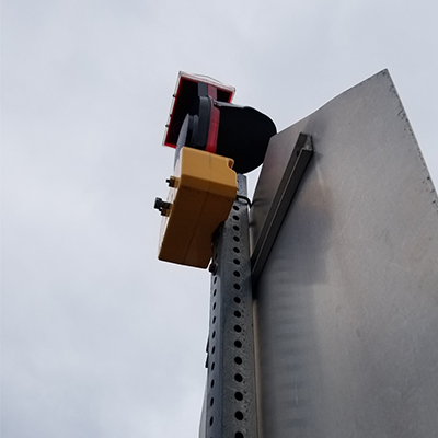 Type B Hooded Solar Barricade Light Mounted Angle View On Back Of Stop Sign Square Post